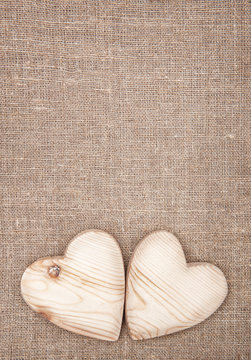 Wooden hearts on the burlap