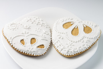 Two decorated gingerbread cookies heart shape