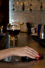 Elegant female hand on a bar counter