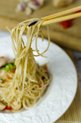 Chow mein noodles with chicken, mushrooms, carrots, onions and c