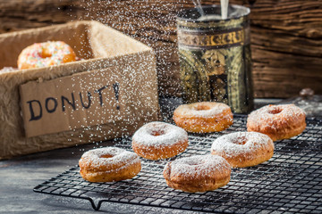 Falling icing sugar on fresh donuts