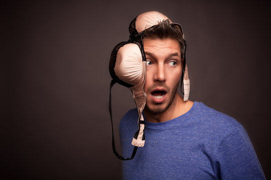 surprised man with bra on head - advertising underwear