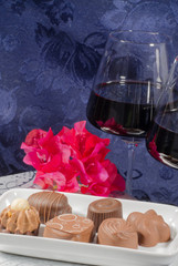 chocolate flowers red wine glasses