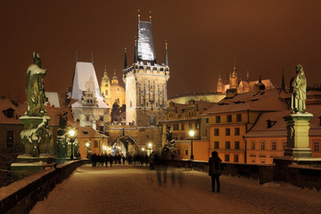 Fototapeta premium Night snowy Prague gothic Castle and St. Nicholas' Cathedral