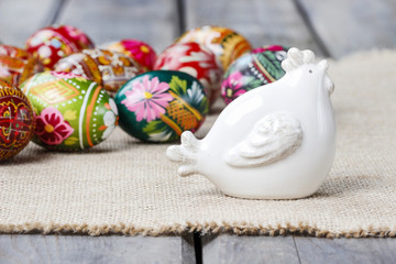 Ceramic hen and easter eggs on the table