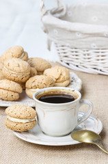 Cup of coffee and stack of french macaroons