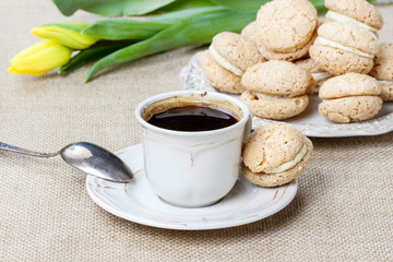 Cup of coffee and stack of french macaroons