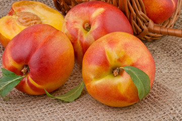 Fototapeta na wymiar peach or nectarine on burlap background