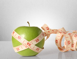 Green apples measured the meter on  white