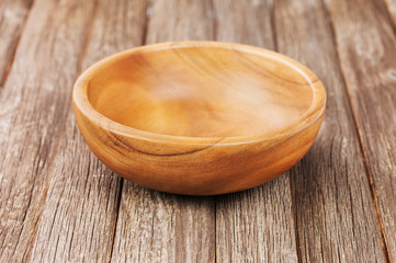 Empty bowl on old wooden surface.
