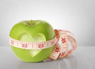 Green apples measured the meter on  white