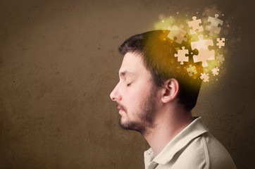 Young person thinking with glowing puzzle mind