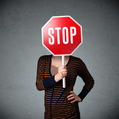 Young woman holding a stop sign