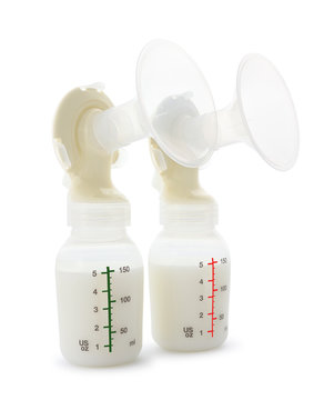 Twin breast pump and milk bottles on white background.
