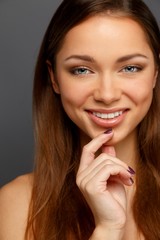 Fototapeta premium Young positive brunette girl with beautiful smile