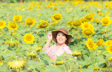 Obraz na płótnie Canvas Portrait women asian in sun flowers field