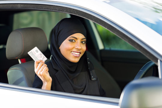 muslim woman showing a driving license