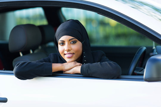 young muslim woman sitting in a car
