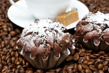 chocolate muffin and cappuccino on coffee beans