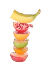 pile of sliced colored fruits isolated on white background