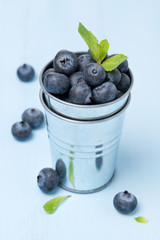 metal bucket with fresh blueberries