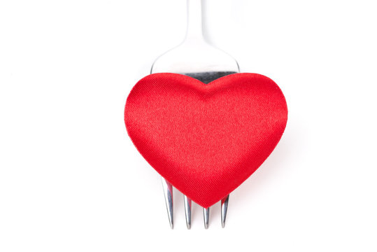 red heart on a fork, concept, close-up, isolated