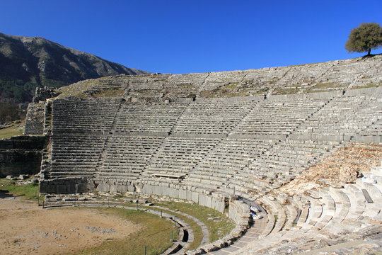 Ancient archaeological site amphitheater or amphitheatre  in Dodoni in Greece with stone seats and steps