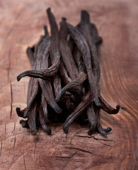 Vanilla pods on wooden background