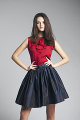 Fototapeta premium Beautiful girl in sexy dress. Portrait in the studio. modern.