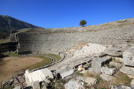 Ancient archaeological site amphitheater or amphitheatre  in Dodoni in Greece with stone seats and steps