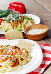 Pasta with shrimps and mashrooms on the wooden table