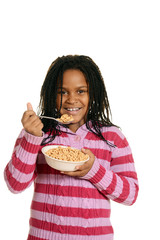 little black girl enjoying bowl of cereal