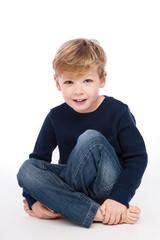 Cute Boy Sitting Cross Legged.