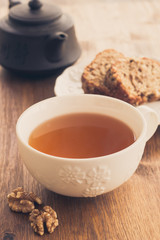 Fototapeta premium Cup of tea with fruit and nut cake