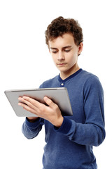 Smart teenager working on a tablet he is holding