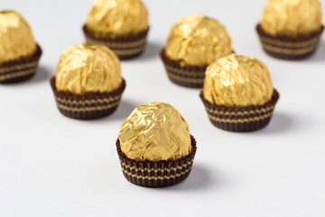 Group of chocolate candies wrapped in golden foil