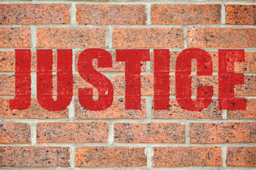 Old brick wall texture with JUSTICE inscription