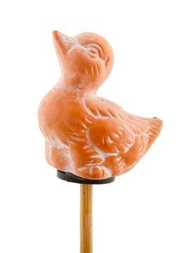 Duck in clay on wooden stick