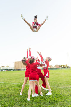 Group of Cheerleaders Performing Stunts