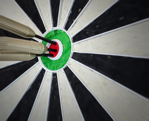 3 darts in the bullseye on a dart board