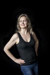Fototapeta premium Blonde Woman with Beautiful Blue Eyes on Black Background