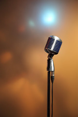 Stylish retro microphone on a colored background