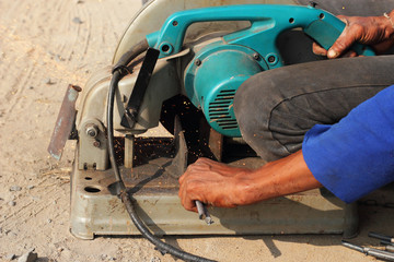 Worker cutting matal with grinder