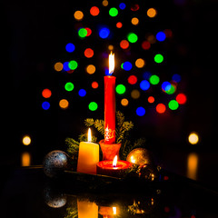 Arrangement with candles, baubles and Christmas tree lights