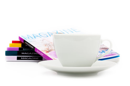 White coffee cup and magazines on white background