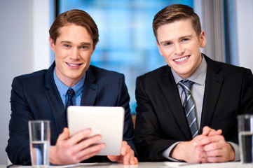 Businessmen browsing on tablet device