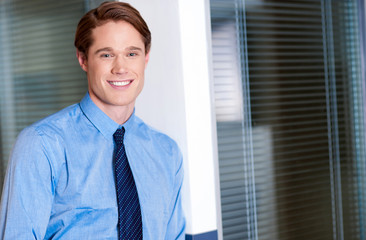 Young smiling relaxed corporate guy