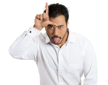 Angry, annoyed young man showing a looser sign