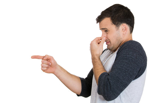 Man pinches his nose, something stinks, very bad smell