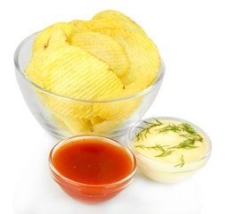 Potato chips in glass bowl and sauces, isolated on white